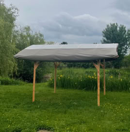 Tonnelle artisanale en bois – vue de face mettant en valeur la symétrie, la stabilité et la présence chaleureuse de la structure.